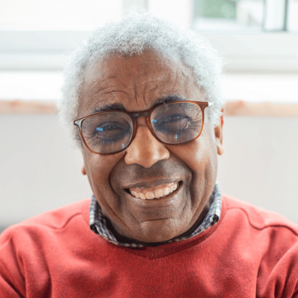 Black senior man smiling with glasses