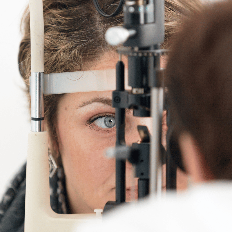 Woman having eyes checked by optometrist