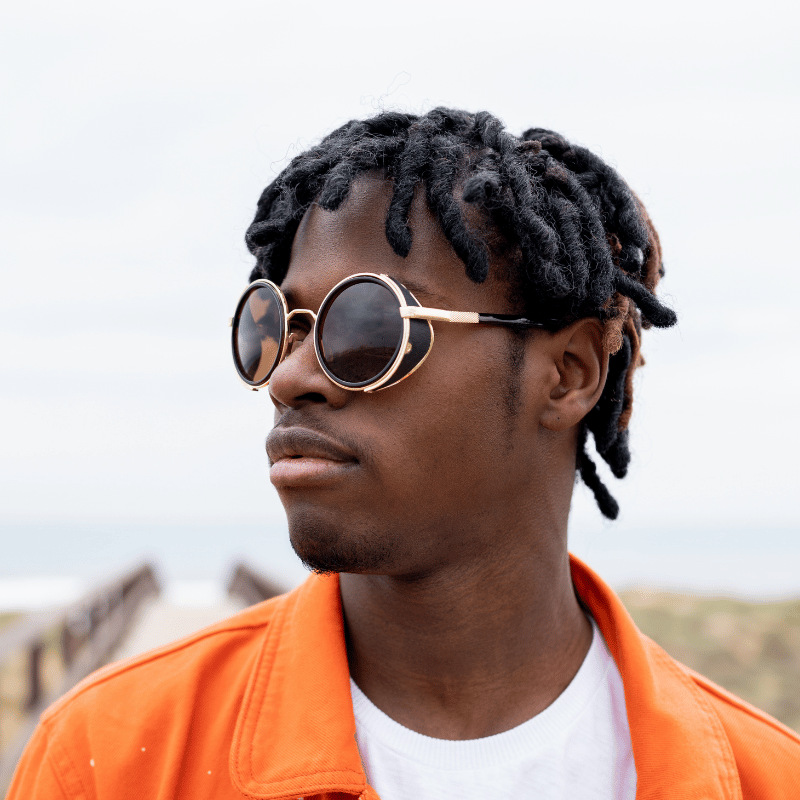 Confident Black man wearing round sunglasses