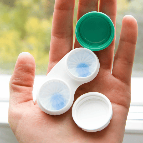 Hand holding contacts in a case