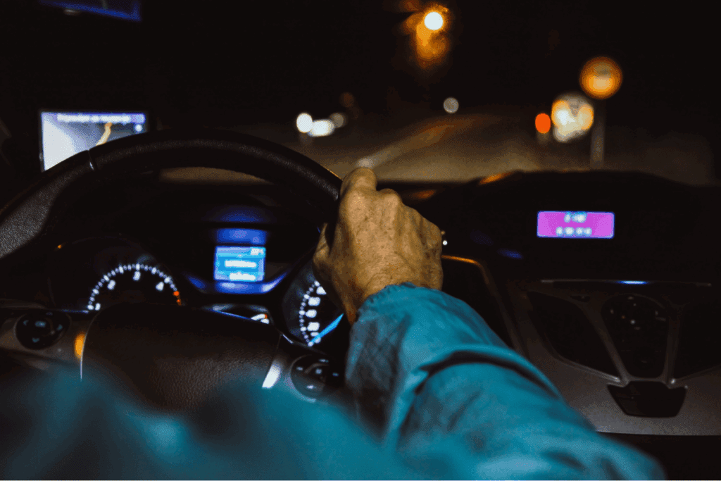 Man driving a car at night