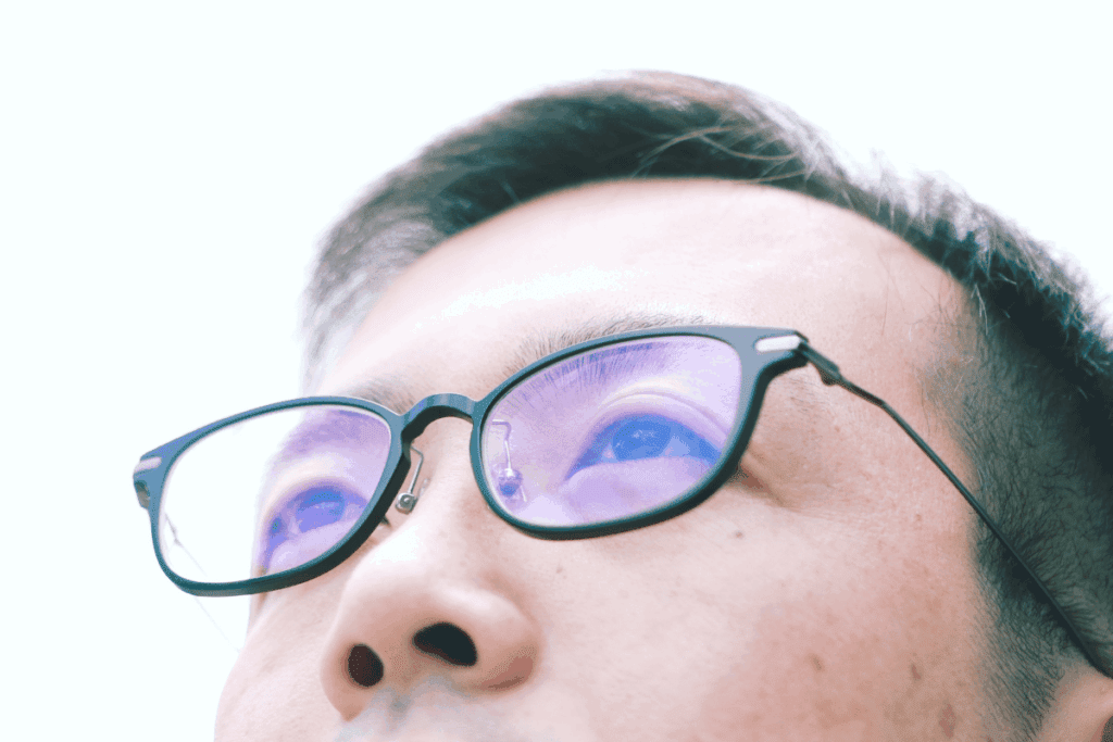 Asian man wearing blue light glasses