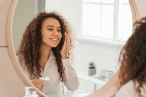 Young woman putting her contact lenses in during morning routine