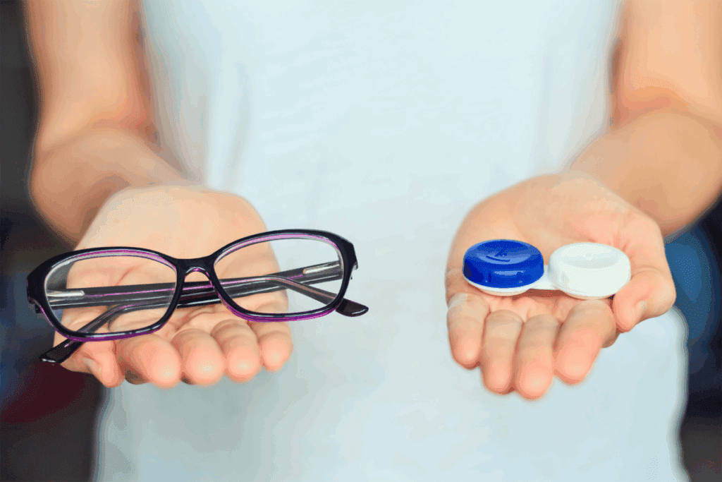 Woman holding glasses in one hand and a contact lens case in the other