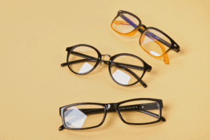 Three pairs of glasses on a yellow table