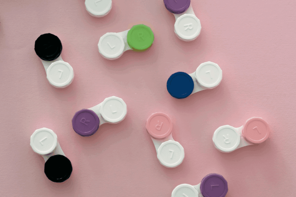 Contact lens cases on a pink background