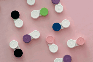 Contact lens cases on a pink background