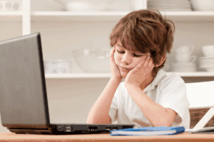 Young boy struggling to complete homework