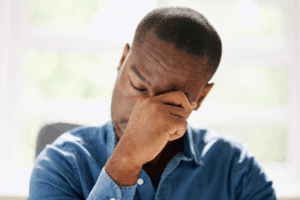 African American man rubbing his eye