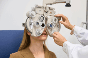 Woman behind an phoropter in an eye exam