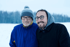 Father and son outside in the winter, wearing glasses and hats