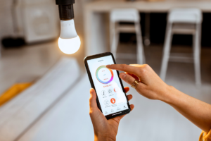Woman adjusting smart lighting in her home