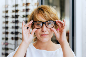 Woman trying on glasses in an optical