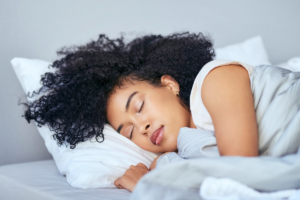 Woman with curly hair sleeping on a pillow
