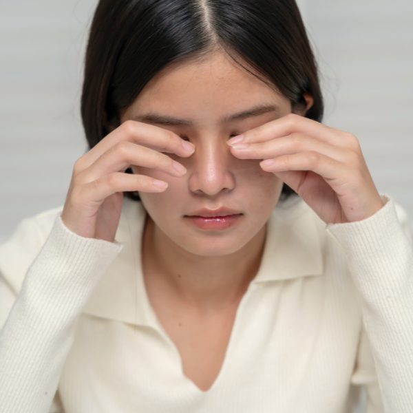 Woman rubbing her eyes