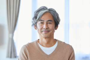 Middle-aged asian man smiling confiently