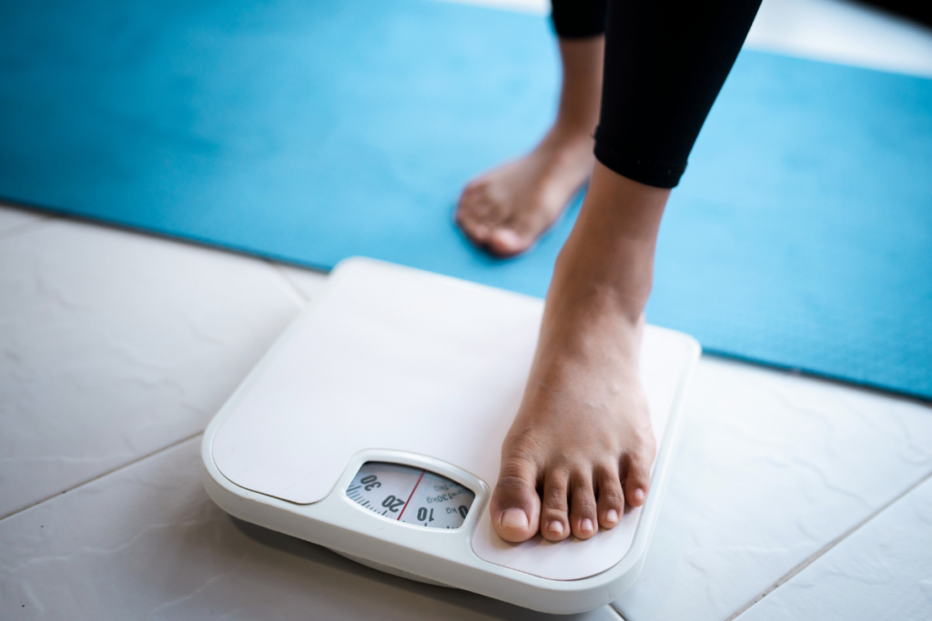 Woman stepping on the scale