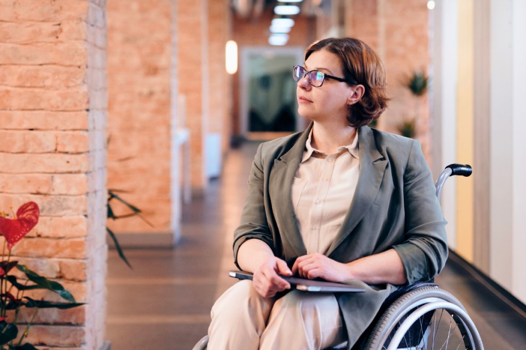 Woman with MS in a wheelchair with a brick background