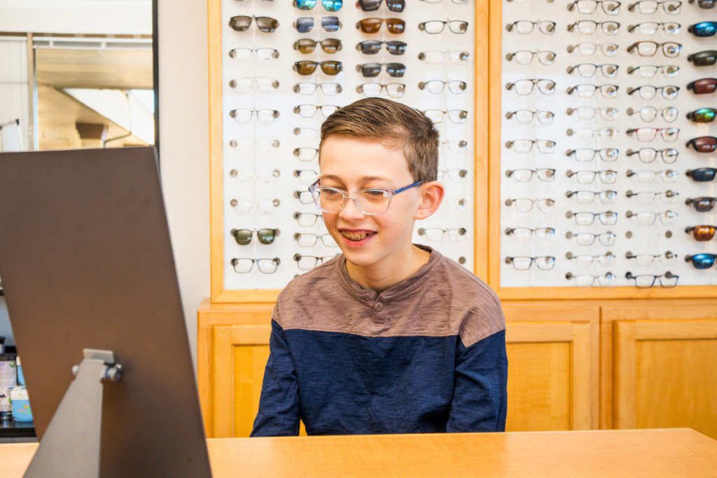 Young boy wearing glasses in an optical